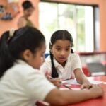 girl-student-helping-her-classma